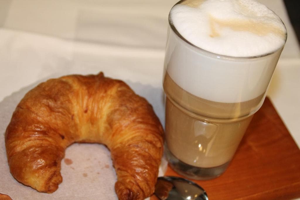Fresh croissant and cappuccino served for breakfast
